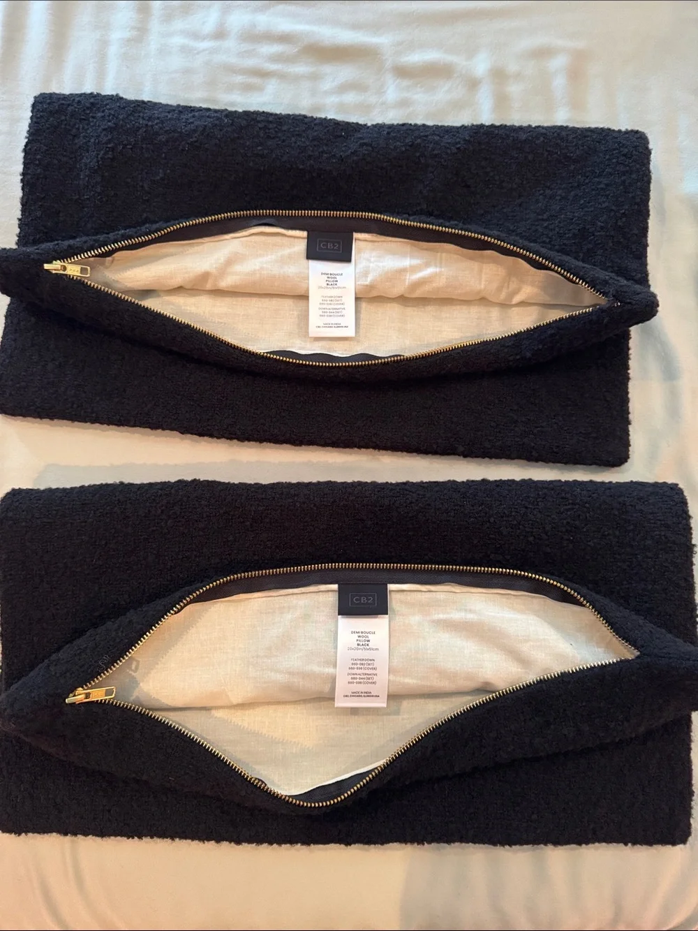 Two CB2 20x20in black boucle pillow covers